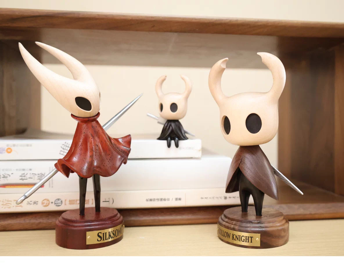 Standing Hollow Knight wooden figure shown beside other figures for display context