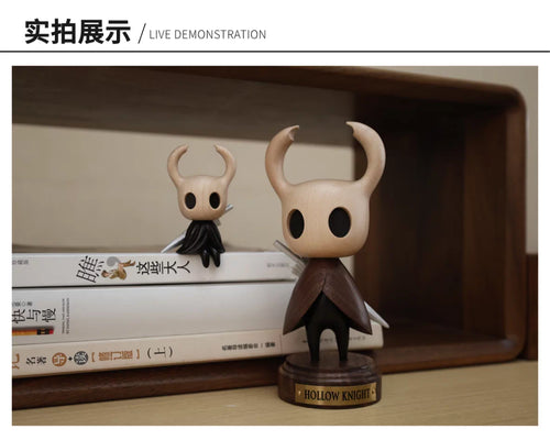 Standing Hollow Knight wooden figure displayed on a shelf with a smaller figure in the background