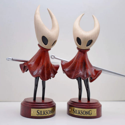 Two Hornet wooden figures shown from different angles