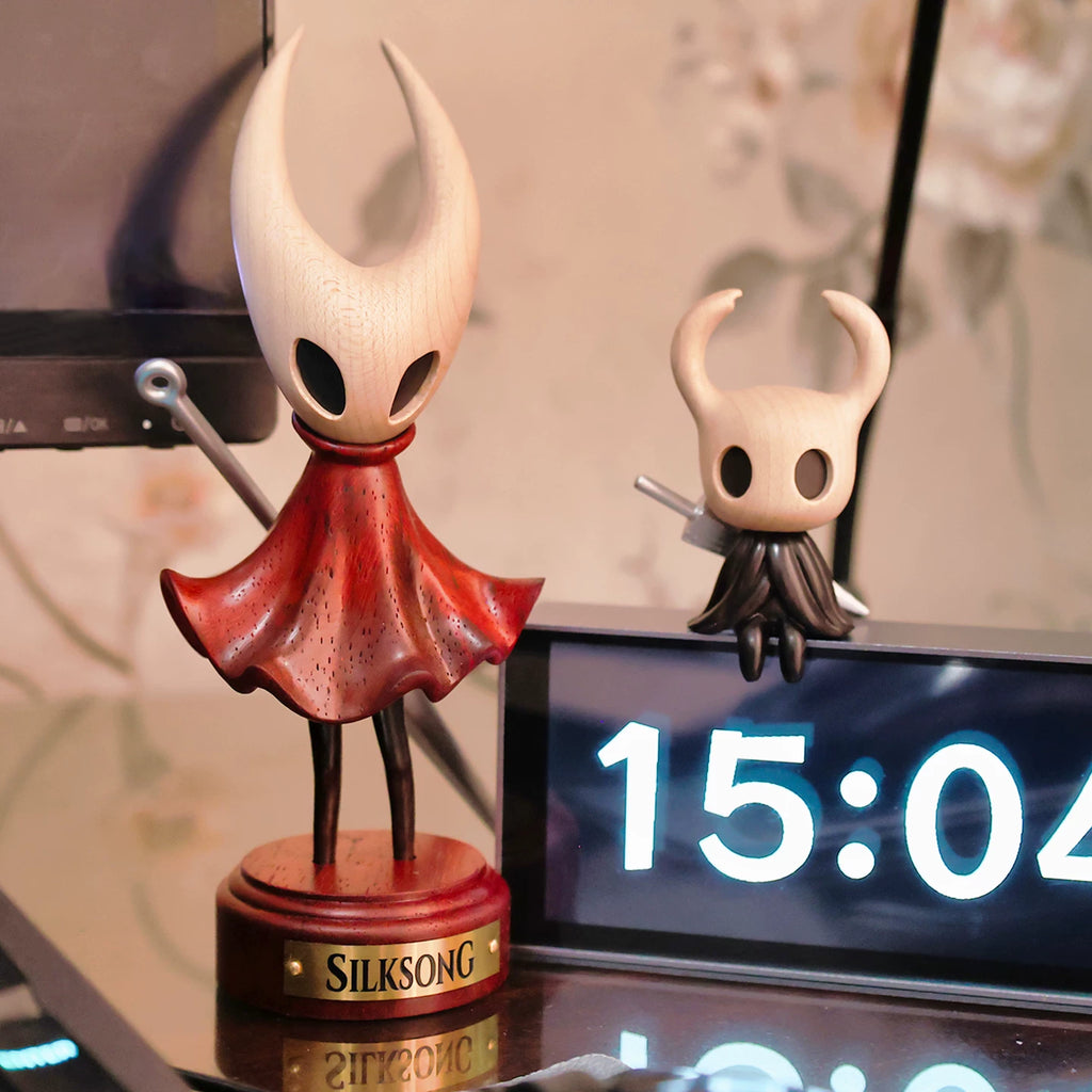 Hornet wooden figure displayed beside a smaller Hollow Knight figure