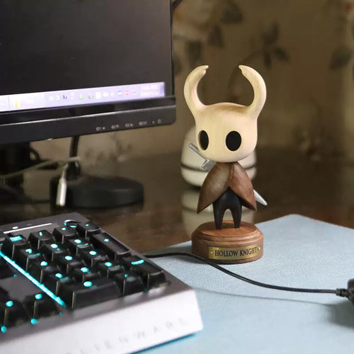 Standing Knight wooden figure displayed beside a keyboard