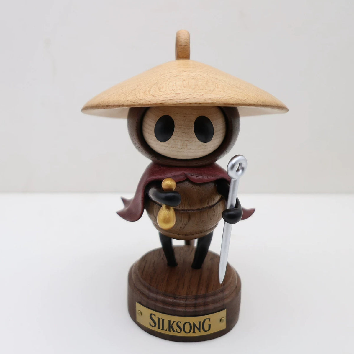 Sherma wooden figure with straw hat and display base